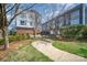 Landscaped common area with bench seating amidst modern townhomes; a welcoming outdoor space at 3621 Vallette Ct, Charlotte, NC 28203