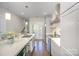 Well-lit kitchen with stainless appliances, subway tile, an island with sink, and double doors leading to patio at 3621 Vallette Ct, Charlotte, NC 28203