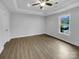 Bedroom with trey ceiling, hardwood floors, ceiling fan and a bright window at 3792 Rolling View Ln, Maiden, NC 28650