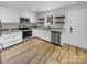 Well-lit kitchen features white cabinets, granite countertops, stainless appliances, and practical floating shelves at 3792 Rolling View Ln, Maiden, NC 28650