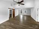 Open-concept living area with wood-look floors, barn door accent, and ample natural light from multiple windows at 3792 Rolling View Ln, Maiden, NC 28650