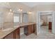 Spacious bathroom featuring double sinks, granite countertops and access to bedroom at 409 Conaway Ct, Waxhaw, NC 28173