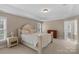 Comfortable bedroom with a large bed, neutral carpet, and ample natural light at 409 Conaway Ct, Waxhaw, NC 28173