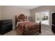 Comfortable bedroom featuring a wooden bed frame, dark accents and natural light at 409 Conaway Ct, Waxhaw, NC 28173