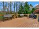 Wooden deck featuring a grill, greenery, and plenty of space for outdoor entertaining at 409 Conaway Ct, Waxhaw, NC 28173