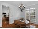 Charming dining room featuring hardwood floors, chandelier, and natural light at 409 Conaway Ct, Waxhaw, NC 28173