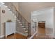 Inviting foyer featuring hardwood floors, staircase with iron spindles, and natural light at 409 Conaway Ct, Waxhaw, NC 28173