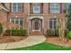 Charming front entrance with a brick facade, manicured landscaping, and an inviting front door at 409 Conaway Ct, Waxhaw, NC 28173