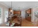 A view of this traditionally designed kitchen features an island, stainless appliances, and a table with chairs at 409 Conaway Ct, Waxhaw, NC 28173