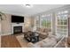 This traditional living room features a fireplace, hardwood floors, lots of light, and neutral paint at 409 Conaway Ct, Waxhaw, NC 28173