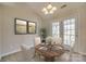 Cozy dining area featuring a round wooden table set for four, adjacent to french doors at 4226 Cornelia Ln, Rock Hill, SC 29732