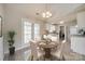 Cozy dining area featuring a round wooden table set for four with french doors at 4226 Cornelia Ln, Rock Hill, SC 29732