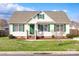 Charming single-story home featuring a well-maintained lawn, cream-colored siding and classic green shutters at 4226 Cornelia Ln, Rock Hill, SC 29732