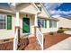 Inviting front porch with a vibrant green door, classic white railing, and brick-lined steps at 4226 Cornelia Ln, Rock Hill, SC 29732