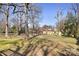 Expansive backyard features mature trees, creating a serene and private outdoor space, and an outdoor fire pit area at 4308 Welling Ave, Charlotte, NC 28208