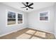 Bright and airy bedroom featuring hardwood floors and two windows that offer ample natural light at 4308 Welling Ave, Charlotte, NC 28208