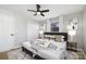 Light and airy bedroom with a ceiling fan, a patterned rug, and decorative pillows on the bed at 4308 Welling Ave, Charlotte, NC 28208