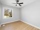 Neutral bedroom with hardwood floors, a large window and ample natural light at 4308 Welling Ave, Charlotte, NC 28208