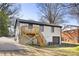 Exterior view of a two-story home with white painted brick, a backyard deck, and garage at 4308 Welling Ave, Charlotte, NC 28208