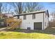 Exterior view of a two-story home with white painted brick, a backyard deck, and garage at 4308 Welling Ave, Charlotte, NC 28208