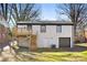 Exterior view of a two-story home with white painted brick, a backyard deck, and garage at 4308 Welling Ave, Charlotte, NC 28208