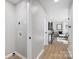 Hallway and laundry area with modern finishes, leading to the living room with natural light at 4308 Welling Ave, Charlotte, NC 28208