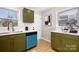 Updated kitchen featuring green cabinets, white countertops, a white subway tile backsplash and stainless steel sink at 4308 Welling Ave, Charlotte, NC 28208