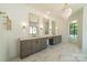 Bathroom with double vanity, elegant mirrors, and chandelier lighting at 4311 Collingwood Dr, Charlotte, NC 28209