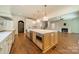 Open kitchen view featuring a large island, stainless steel appliances, and a view to the living room at 4311 Collingwood Dr, Charlotte, NC 28209