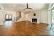 Bright living room with wood floors, fireplace, ceiling fan, staircase, and sliding glass doors at 4311 Collingwood Dr, Charlotte, NC 28209