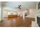 Open floor plan view featuring hardwood floors, a kitchen with island, and a living room with a fireplace at 4311 Collingwood Dr, Charlotte, NC 28209