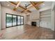 Living room features hardwood floors, a stone fireplace, built-in shelving, and sliding doors to the patio at 4311 Collingwood Dr, Charlotte, NC 28209