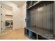 Mudroom features a built-in bench and storage, adjacent to the laundry room at 4311 Collingwood Dr, Charlotte, NC 28209