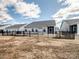 View of the fenced backyard, showing ample space, tidy lawn, and neighboring houses beyond at 6420 Cambridge Dr, Harrisburg, NC 28075