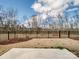 The backyard offers a generous grassy area, enclosed by a black iron fence, perfect for outdoor activities at 6420 Cambridge Dr, Harrisburg, NC 28075