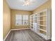 Bedroom featuring a large built-in bookshelf, natural light from two windows, and a ceiling fan at 6420 Cambridge Dr, Harrisburg, NC 28075