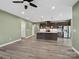 Open concept floor plan showcases a spacious living room and adjacent kitchen with island and appliances at 6420 Cambridge Dr, Harrisburg, NC 28075