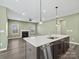 Open-concept living space features a modern kitchen island, fireplace, and plenty of natural light at 6420 Cambridge Dr, Harrisburg, NC 28075