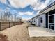 A spacious backyard featuring a well-maintained lawn, a concrete patio, and bordered by a classic iron fence at 6420 Cambridge Dr, Harrisburg, NC 28075