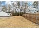 Wide backyard featuring wood and chain link fences, with a partial view of the home's exterior at 813 Carrid Dr, Gastonia, NC 28052