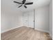 Bedroom features light hardwood floors, ceiling fan, and double closet at 813 Carrid Dr, Gastonia, NC 28052