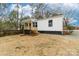 Charming single-story home featuring a covered porch with wood stairs and black painted foundation at 813 Carrid Dr, Gastonia, NC 28052