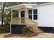 Home featuring a cozy front porch with wood stairs and black foundation at 813 Carrid Dr, Gastonia, NC 28052