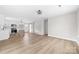 Spacious living room with open floor plan featuring new floors, neutral colors and sliding barn door at 813 Carrid Dr, Gastonia, NC 28052