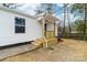 Side view of charming home with wooden porch, steps, white siding, and well-maintained yard at 813 Carrid Dr, Gastonia, NC 28052