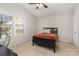 Cozy bedroom featuring a ceiling fan, natural light, and neutral carpet at 9562 Littleleaf Dr, Charlotte, NC 28215