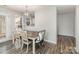 Charming dining area featuring wood floors and an open view to the kitchen at 9562 Littleleaf Dr, Charlotte, NC 28215