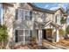 Charming townhouse exterior featuring neutral siding, green shutters, and a welcoming front porch at 9562 Littleleaf Dr, Charlotte, NC 28215