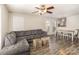 Spacious living room and dining area featuring modern gray floors and a large gray sectional sofa at 9562 Littleleaf Dr, Charlotte, NC 28215