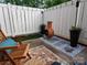 Charming patio with wooden fence, chair, and a chiminea at 9562 Littleleaf Dr, Charlotte, NC 28215